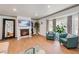 Cozy living room featuring a fireplace, hardwood floors, and lots of natural light at 6979 E Fremont Ave, Centennial, CO 80112