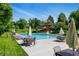A community pool with lounge chairs, tables, and umbrellas, creating a relaxing and enjoyable outdoor space at 6979 E Fremont Ave, Centennial, CO 80112