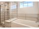 A modern bathroom featuring a glass-enclosed shower, soaking tub, and neutral-toned tile at 2387 Bristol St, Superior, CO 80027