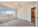 This light-filled bedroom features large windows offering neighborhood views, plush carpeting, and neutral decor at 2387 Bristol St, Superior, CO 80027