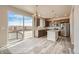 Modern kitchen featuring stainless steel appliances, granite countertops, an island, and a sliding door to the outside at 2387 Bristol St, Superior, CO 80027