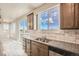 Bright kitchen featuring granite countertops, stainless steel appliances, and seamless flow into the adjacent living spaces at 2387 Bristol St, Superior, CO 80027