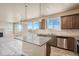 Bright kitchen with granite counters, island seating, stainless appliances, and a seamless flow into the living area at 2387 Bristol St, Superior, CO 80027