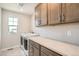 Functional laundry room with front-load washer/dryer and ample counter space at 2387 Bristol St, Superior, CO 80027
