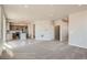 Open-concept living area showcasing a seamless transition to the modern kitchen and stylish light-colored floors at 2387 Bristol St, Superior, CO 80027