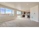 Inviting living space with a large window and sliding door, adjacent to a modern kitchen with an island at 2387 Bristol St, Superior, CO 80027