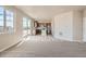 Bright living room flowing into a kitchen with stainless steel appliances and an island, light-colored floor at 2387 Bristol St, Superior, CO 80027