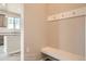 Mudroom area includes a bench with hooks for organized storage, plus views into the kitchen area at 2387 Bristol St, Superior, CO 80027