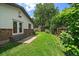 Well-maintained backyard with lush green grass, mature trees, and a privacy fence at 1018 Kelly Pl, Longmont, CO 80501