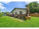 View of backyard showing lawn, brick facade, and side access to house at 1018 Kelly Pl, Longmont, CO 80501