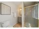 Bright bathroom featuring a shower with gold trim, modern vanity, and stylish decorative accents at 1018 Kelly Pl, Longmont, CO 80501