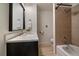 Modern bathroom with an updated vanity, framed mirror, and a shower-tub combination with tiled walls at 1018 Kelly Pl, Longmont, CO 80501