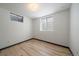 Bright bedroom with hardwood floors and natural light streaming through the window at 1018 Kelly Pl, Longmont, CO 80501