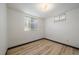 Cozy room with hardwood floors and natural light streaming through two windows at 1018 Kelly Pl, Longmont, CO 80501
