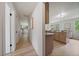 Hallway view into modern kitchen featuring stainless appliances and center island with seating at 1018 Kelly Pl, Longmont, CO 80501