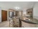 Bright kitchen with updated appliances, a center island with seating, and modern lighting at 1018 Kelly Pl, Longmont, CO 80501
