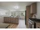 Modern kitchen with island, seating, stainless steel appliances, and access to back patio at 1018 Kelly Pl, Longmont, CO 80501