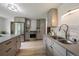Well-lit kitchen featuring updated appliances, cabinetry, and a stainless steel sink at 1018 Kelly Pl, Longmont, CO 80501
