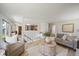 Open living room with view into kitchen, light wood floors, and comfortable seating at 1018 Kelly Pl, Longmont, CO 80501