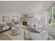Bright living room featuring a brick fireplace, plush seating, and natural light at 1018 Kelly Pl, Longmont, CO 80501