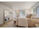 Bright main bedroom featuring a mirror, bench seat, natural light, and neutral decor at 1018 Kelly Pl, Longmont, CO 80501