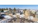 Aerial view of homes with snow-covered lawns in a neighborhood with mountains in the distance at 4241 Brookwood Pl, Highlands Ranch, CO 80130