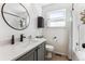 Bright bathroom features a round mirror, a speckled vanity top, and a shower/tub with a decorative shower curtain at 4241 Brookwood Pl, Highlands Ranch, CO 80130