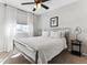 Bedroom featuring a metal bed frame, ceiling fan, and a window with sheer white curtains at 4241 Brookwood Pl, Highlands Ranch, CO 80130