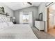 Bedroom with carpet, gray walls, tufted headboard, and large windows with sheer white curtains at 4241 Brookwood Pl, Highlands Ranch, CO 80130