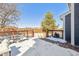 Snow-covered deck with wood railing, featuring outdoor seating, a grill, and clear views of the fenced yard at 4241 Brookwood Pl, Highlands Ranch, CO 80130