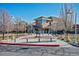 A modern building featuring a statue of a deer, surrounded by benches and budding trees at 4241 Brookwood Pl, Highlands Ranch, CO 80130