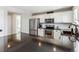 Kitchen featuring a stainless steel refrigerator, oven, black counters, and white cabinets at 4241 Brookwood Pl, Highlands Ranch, CO 80130