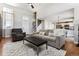 Spacious and well-lit living room with an open layout and a view into the kitchen at 4241 Brookwood Pl, Highlands Ranch, CO 80130