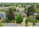 An aerial view showcases this property's prime location, backing to green space and a community lake at 4398 W Lake S Cir, Littleton, CO 80123