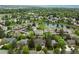 Aerial view of the community highlighting the properties, trees, and the lake nearby at 4398 W Lake S Cir, Littleton, CO 80123