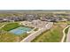 Aerial view showcasing community amenities: swimming pool, tennis courts, parking, and clubhouse at 81 Simmental Loop, Castle Rock, CO 80104