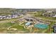 Aerial view showcasing community amenities: pool, tennis courts, clubhouse, and beautifully landscaped green spaces at 81 Simmental Loop, Castle Rock, CO 80104