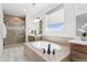Modern bathroom featuring a soaking tub, glass-enclosed shower, and stylish vanity at 81 Simmental Loop, Castle Rock, CO 80104