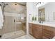 Spa-like bathroom with a large shower, built-in bench, and wooden vanity at 81 Simmental Loop, Castle Rock, CO 80104