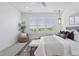 Bright bedroom featuring neutral decor, a large window with natural light, and a cozy seating area at 81 Simmental Loop, Castle Rock, CO 80104