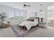 Relaxing bedroom featuring large windows, neutral colors, a ceiling fan, and modern bedside tables at 81 Simmental Loop, Castle Rock, CO 80104