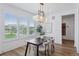 Bright dining area with large windows, modern lighting, and a cozy dining set, perfect for entertaining at 81 Simmental Loop, Castle Rock, CO 80104