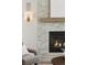 A stone fireplace with gas insert and mantel is a focal point in the living room at 81 Simmental Loop, Castle Rock, CO 80104