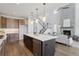 Open kitchen with stainless steel appliances, large island, pendant lighting, and an open view to the Gathering room at 81 Simmental Loop, Castle Rock, CO 80104