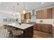 Spacious open-concept kitchen with a large island, stainless steel appliances, and modern pendant lighting at 81 Simmental Loop, Castle Rock, CO 80104