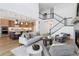 Open-concept living space with a fireplace, soaring ceilings, and modern kitchen with island seating, perfect for entertaining at 81 Simmental Loop, Castle Rock, CO 80104