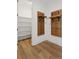Mud room featuring built-in wooden shelves and hooks, perfect for keeping organized, with luxury vinyl floors at 81 Simmental Loop, Castle Rock, CO 80104
