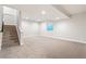 Spacious finished basement with neutral carpet and a large window for natural light at 21127 E 62Nd Dr, Aurora, CO 80019