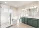 Primary bathroom featuring double sink vanity, shower and tub with sleek, modern finishes at 21127 E 62Nd Dr, Aurora, CO 80019