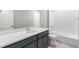 Modern bathroom with a single vanity sink and a shower-tub combo with white subway tile at 21127 E 62Nd Dr, Aurora, CO 80019